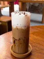 Iced coffee mocha on wooden table in coffee shop photo