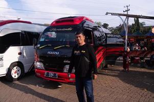 Pasuruan, Indonesia, June 2022 - a person in front of a car in a parking lot. Ceng Ho Mosque parking lot, Pasuruan. photo