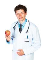 Portrait of a smiling male doctor holding red apple on white photo