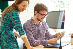 Man and woman looking to a color paint palette at home office photo