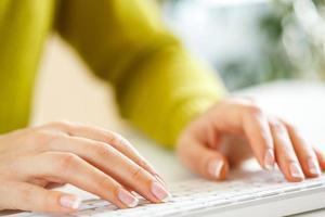 Woman office worker typing on the keyboard photo