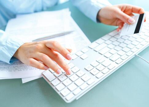 Hands using computer and credit card photo