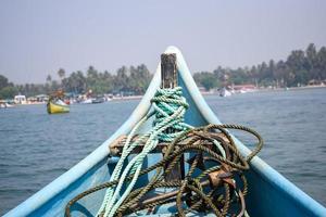 Amazing view from over long tail motor boat in Arabian sea in Goa, India, Ocean view from wooden boat with old ropes photo