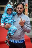 New Delhi, India - December 04 2022 - Unidentified people showing their ink-marked fingers after casting votes in front of polling booth of east Delhi area for MCD local body Elections 2022 photo