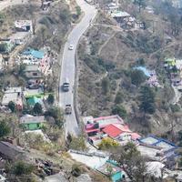 Aerial top view of traffic vehicles driving at mountains roads at Nainital, Uttarakhand, India, View from the top side of mountain for movement of traffic vehicles photo