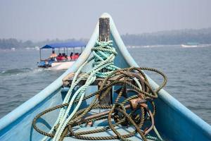 Amazing view from over long tail motor boat in Arabian sea in Goa, India, Ocean view from wooden boat with old ropes photo