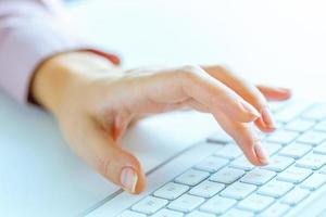 Woman office worker typing on the keyboard photo