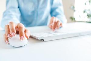 Woman office worker typing on the keyboard photo