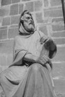 monochrome photography of religious statue m holy man photo