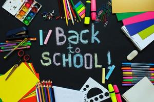 School supplies on blackboard background ready for your design photo