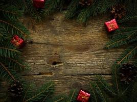 Christmas tree branches with christmas decorations on wooden texture photo