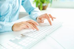 Woman office worker typing on the keyboard photo