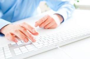 Men office worker typing on the keyboard photo