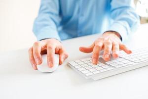 Men office worker typing on the keyboard photo