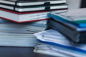 Accounting and taxes. Pile of magazine, notebook and books closeup photo