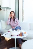 Happy businesswoman talking on the phone in a coffee shop photo