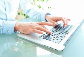 Men office worker typing on the keyboard photo