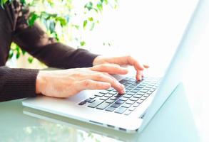 Men office worker typing on the keyboard photo