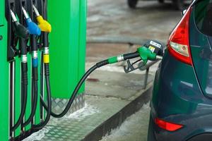 Car refueling on a petrol station in winter photo