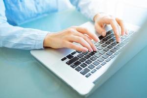 Woman office worker typing on the keyboard photo