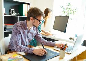 Successful young woman and man working from home photo