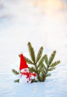 Happy snowman standing in winter christmas landscape photo