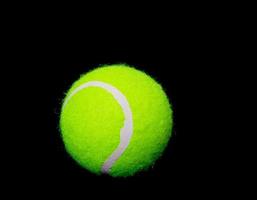 Tennis ball on black background photo