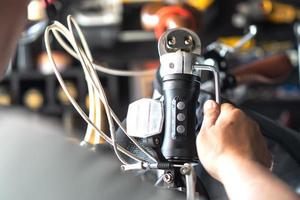 Technician makes adjustments to handlebar Stem on a folding bicycle working in workshop , Bicycle Repair and maintenance concept photo