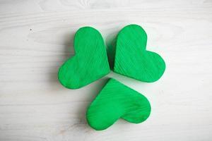 Green shamrock clovers on white wooden background photo