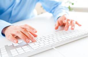 Men office worker typing on the keyboard photo