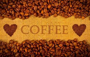 Coffee grains on the burlap background photo