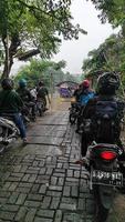 Sidoarjo, Jawa timur, Indonesia, 2023 -  people lining up boats to cross the river photo