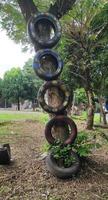 Used car tires are installed on trees in stages photo