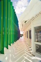 Beautiful building with green columns. Shadows on the snow photo