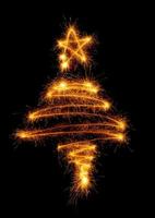 Christmas tree made by sparkler on a black photo