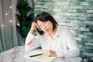 Handsome young  businesswoman sleep  at home with laptop on desk photo