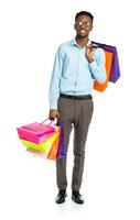 Happy african american man holding shopping bags on white background. Shopping photo