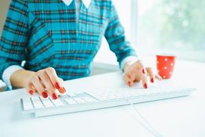 Woman office worker typing on the keyboard photo