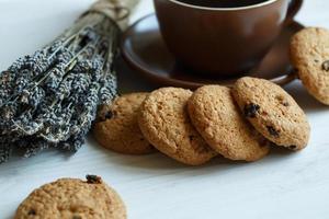 Lavender, cookies and cup of tea on white wooden background photo