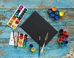 Art painting materials on wooden background photo