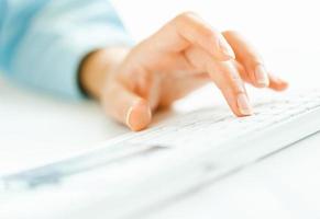 Woman office worker typing on the keyboard photo