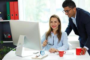 Beautiful young woman and man working from home office photo