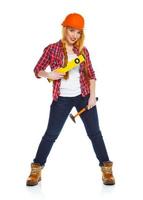 Young woman in helmet with the work tools on a white photo