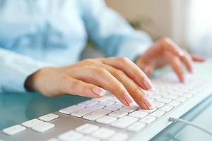 Woman office worker typing on the keyboard photo