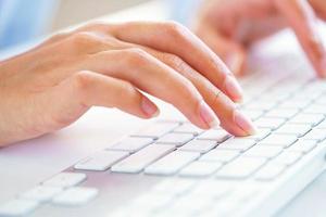 Female woman office worker typing on the keyboard photo