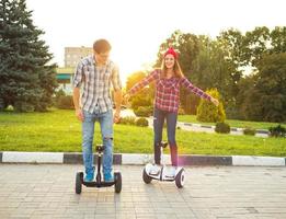 Young couple riding hoverboard photo