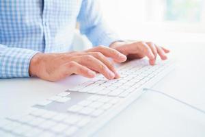 Men office worker typing on the keyboard photo