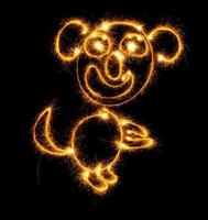 Monkey made sparklers on black photo