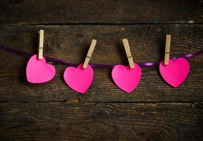 Pink heart paper cut out with clothes pins photo