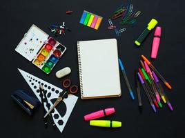 School supplies on blackboard background photo